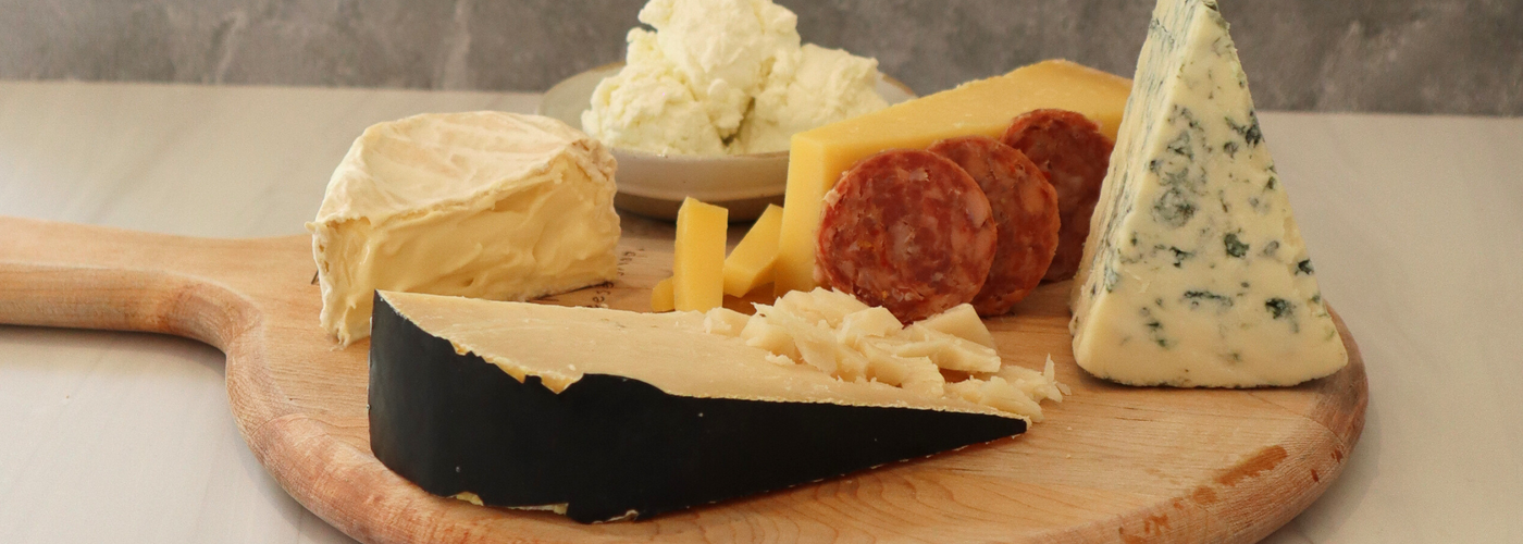 Cheese is healthy.  Image of multiple pieces of cheese on a tray.