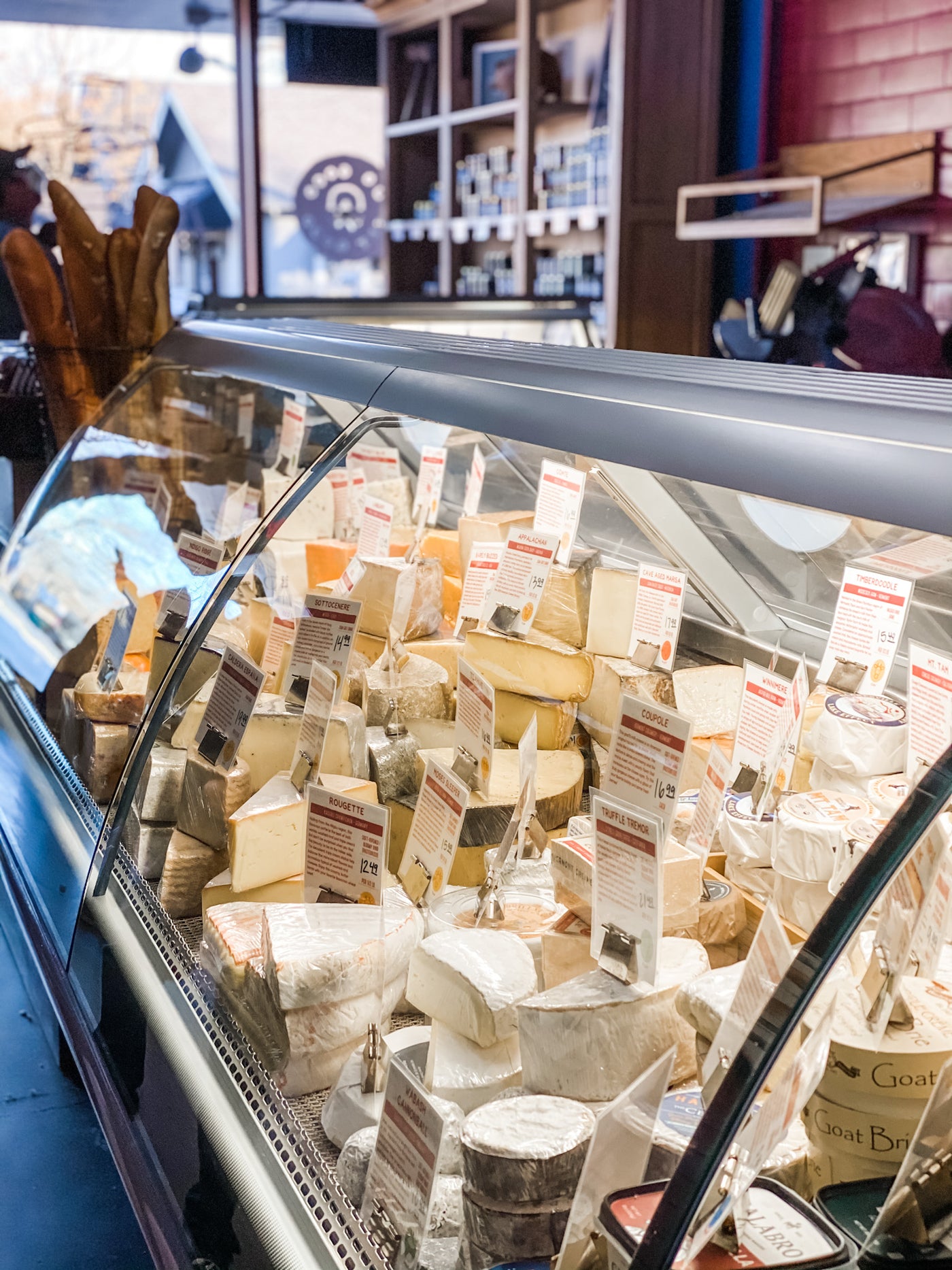 Cheesemonger - works behind a cheese case like the one in the image