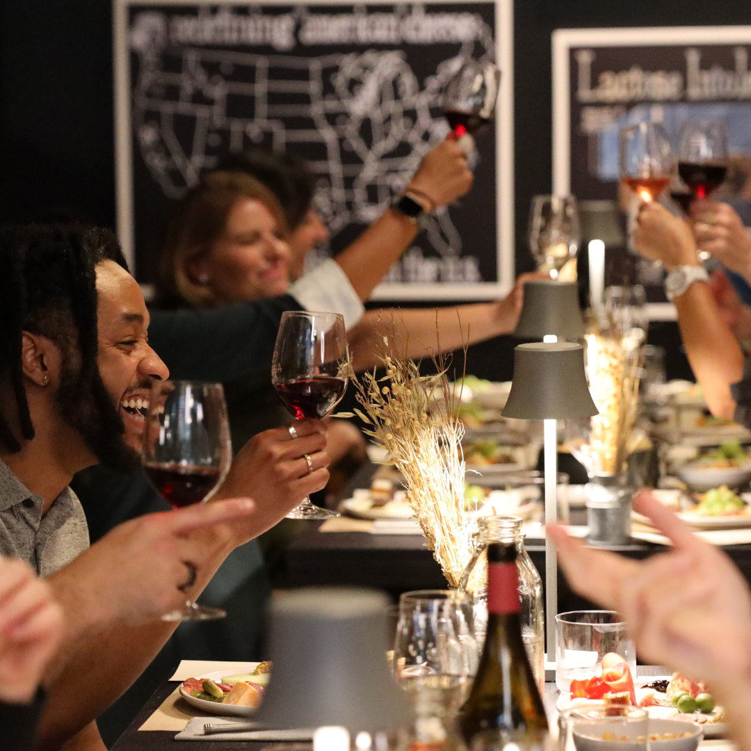 People enjoying a meal together with wine glasses in a casual setting.