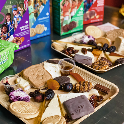 Assorted snacks on a tray with boxes in the background