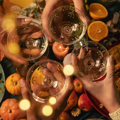 hands cheersing over a thanksgiving spread