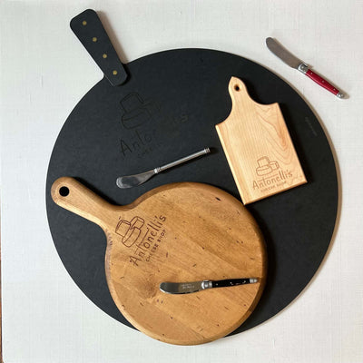 Display of three cutting boards and three knives all of various sizes