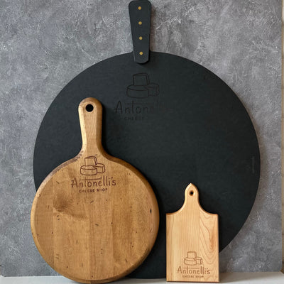 Three cutting boards of different sizes with Antonelli's Cheese Shop logo