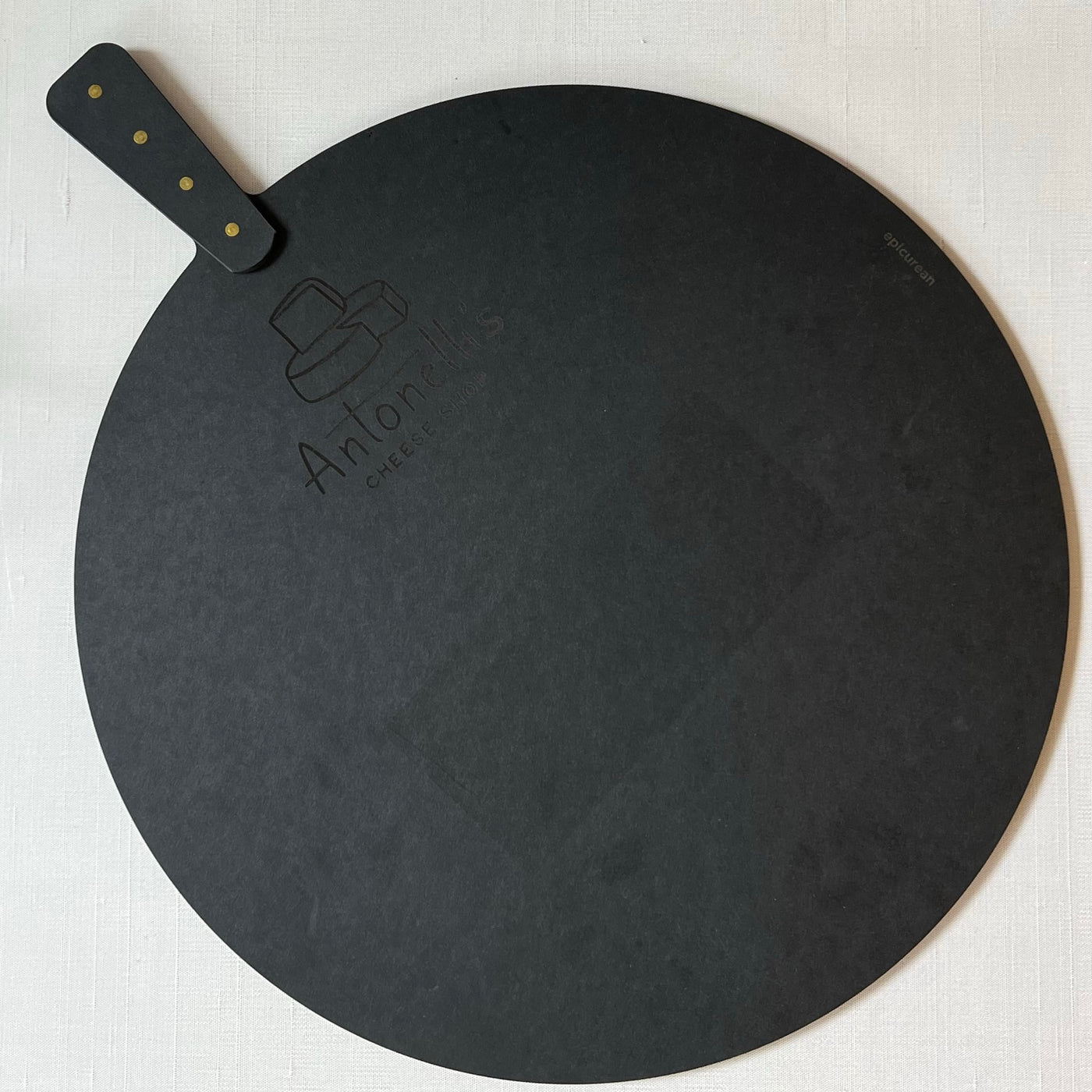 Black 17 inch round cutting board with Antonellis Cheese Logo
