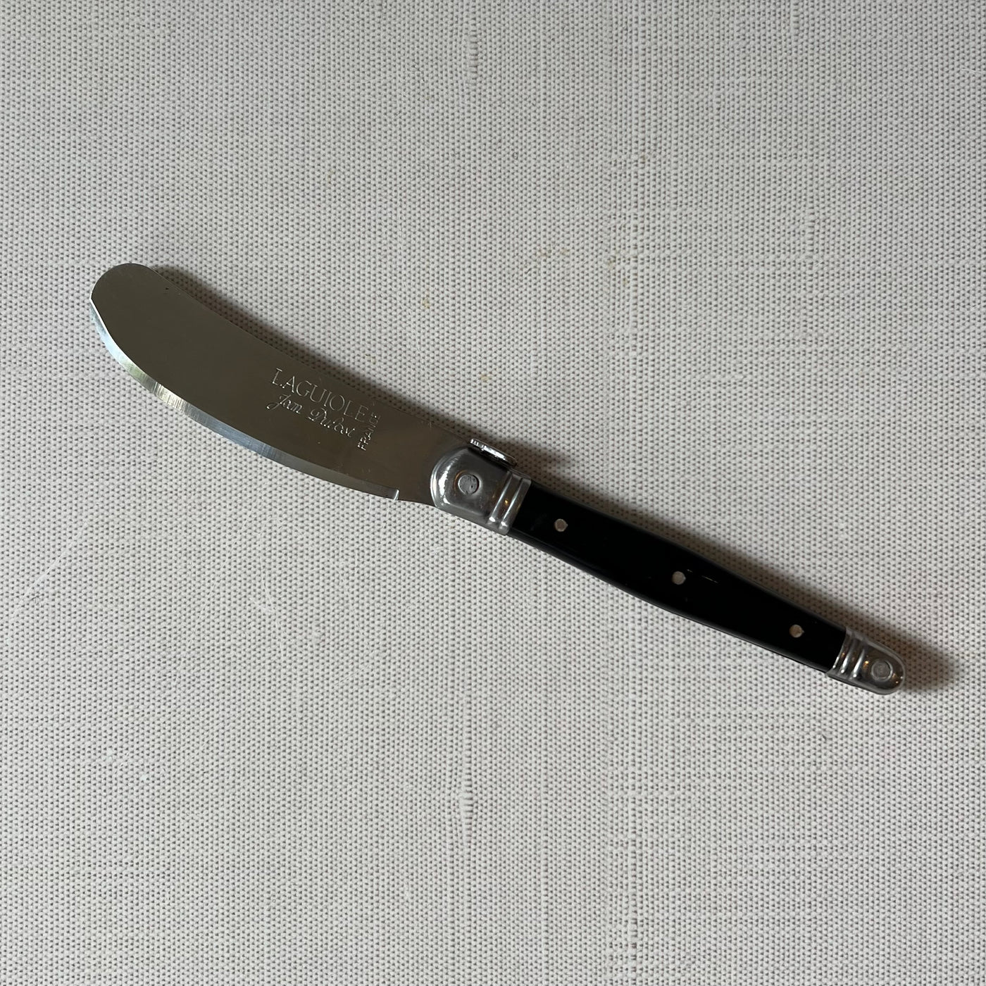 Black handled knife with silver cutting edge