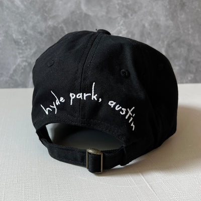 back of black hat with the words "hyde Park, Austin"