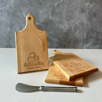 Three small cutting boards with Antonelli's Cheese logo and Stainless steel logo