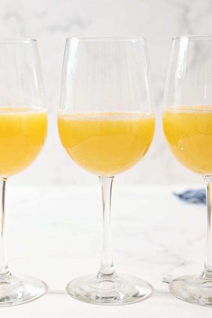 Bottomless mimosas near me brunch in wine glasses, available in alcoholic and non-alcoholic options.