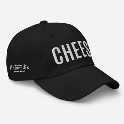 Black dad hat with "CHEESE" embroidered, low-profile, adjustable strap.