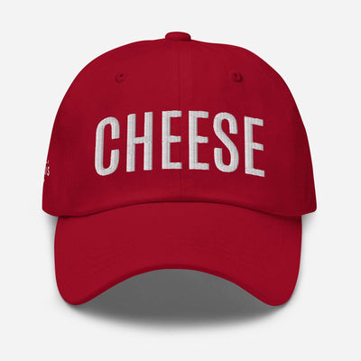 Red "CHEESE" embroidered dad hat with adjustable strap and curved visor, made from chino cotton twill.