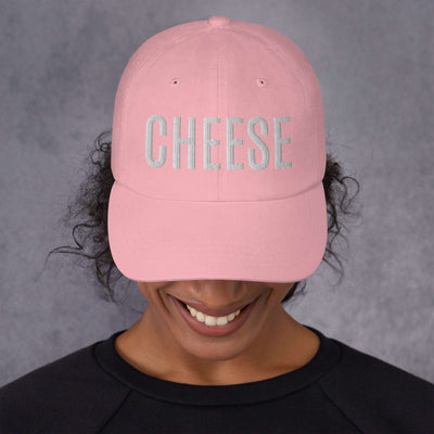 Pink "CHEESE" hat with embroidered text, featuring a low-profile dad hat style with an adjustable strap and curved visor.