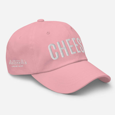 Pink dad hat with "CHEESE" text, low profile, adjustable strap, curved visor.