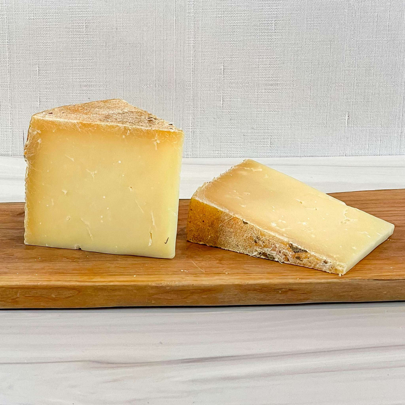 Truckle cheese from Homestead Creamery, Missouri, firm raw cow milk cheddar.