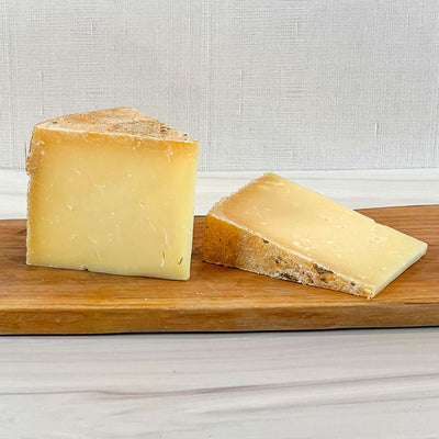 Truckle cheese from Homestead Creamery, Missouri, firm raw cow milk cheddar.