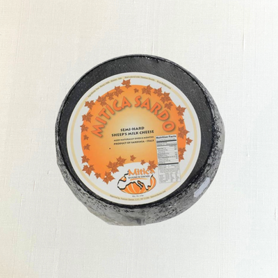 Mitica Sardo sheep's milk cheese wheel from Sardinia, aged 8 months.