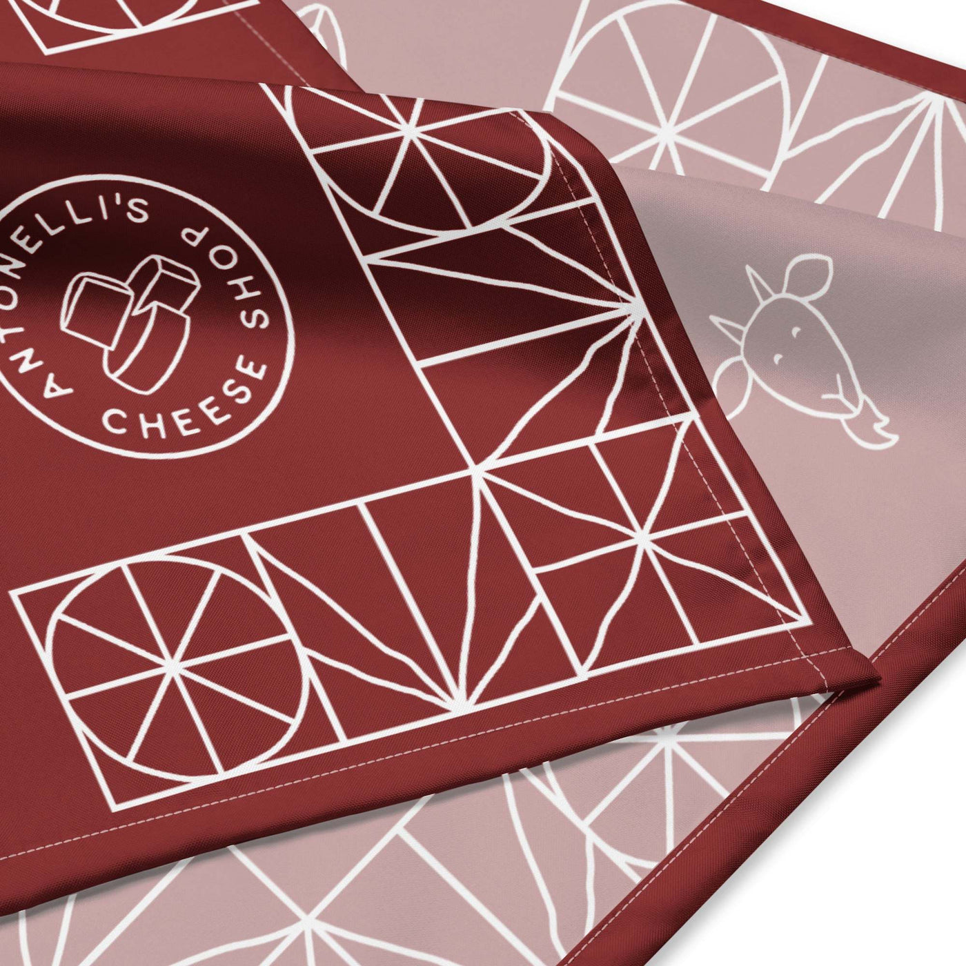 All-over print bandana with geometric design and cheese shop logo.