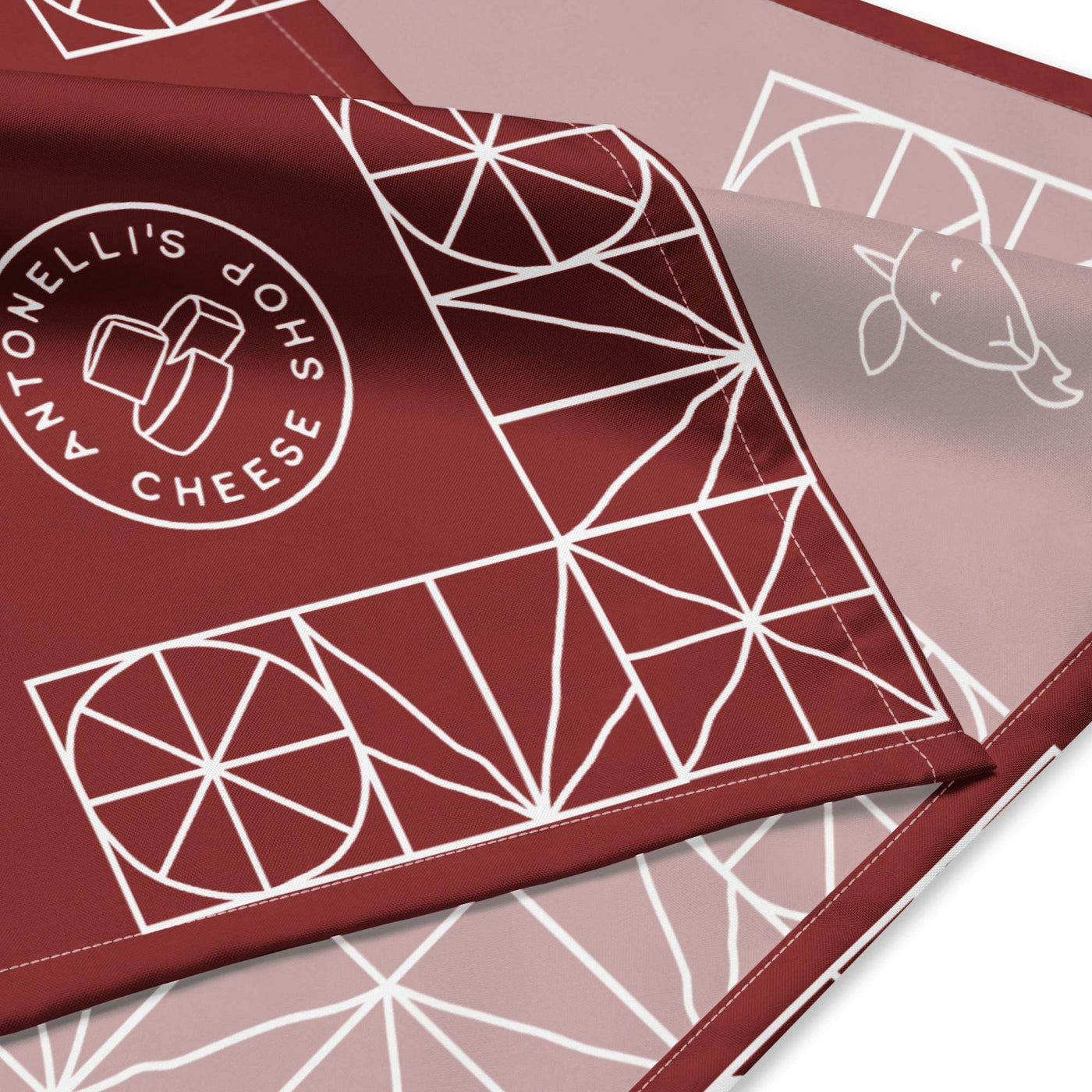 All-over print bandana with geometric design and branding, made of lightweight microfiber polyester.