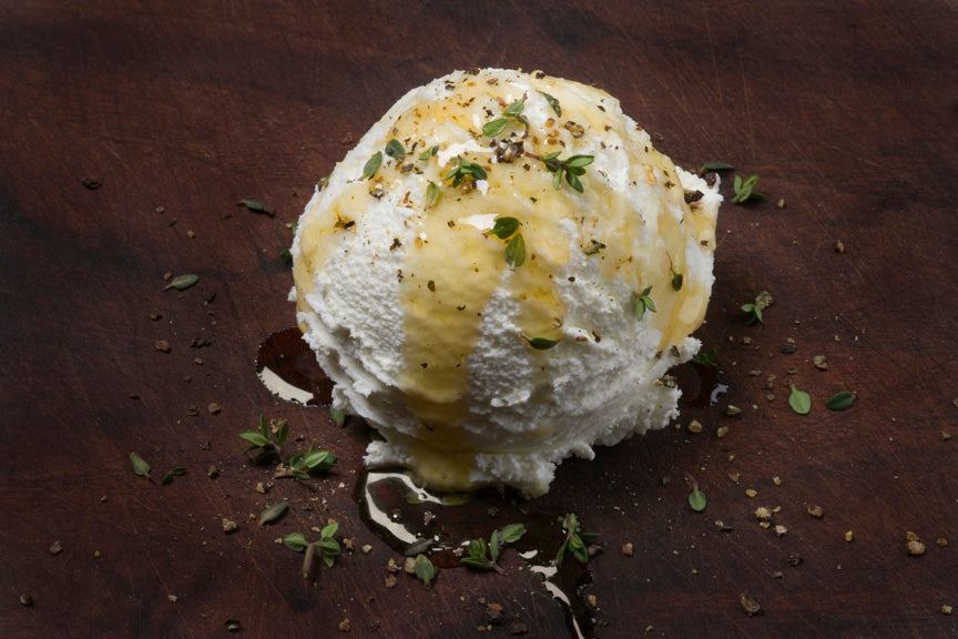 Fresh goat cheese with honey, black pepper, and thyme from Pure Luck Dairy in Dripping Springs, TX.