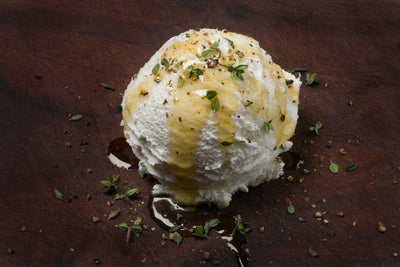 Fresh goat cheese with honey, black pepper, and thyme from Pure Luck Dairy in Dripping Springs, TX.