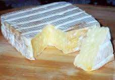 Pont-l'Évêque cheese with creamy texture, washed rind, crafted by E. Graindorge in France.